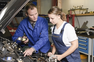 mentorship and train support - man in workshop with young trainee apprentice