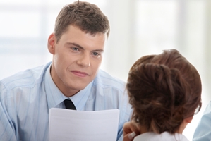 man in intervew interviewee in forground in a office