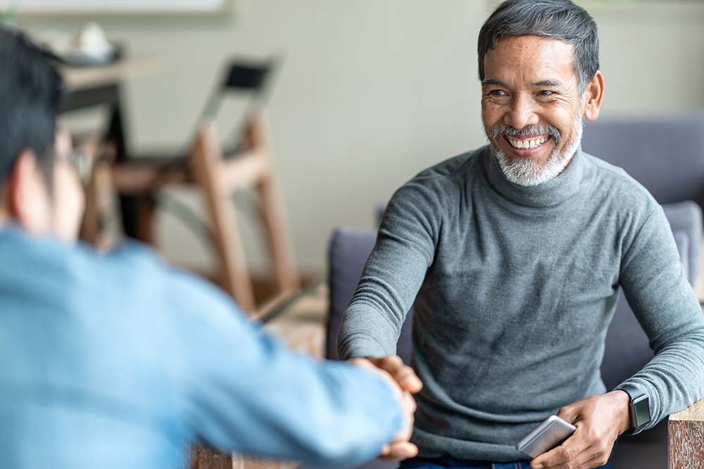 Older man shaking hand at job interview