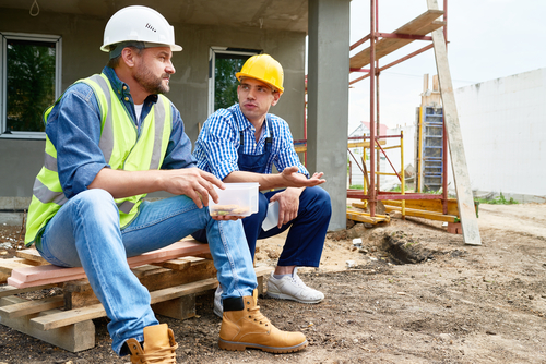 Two construction workers talking on their break