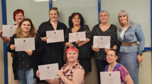 Women from Kickstarter Program holding graduation certificates