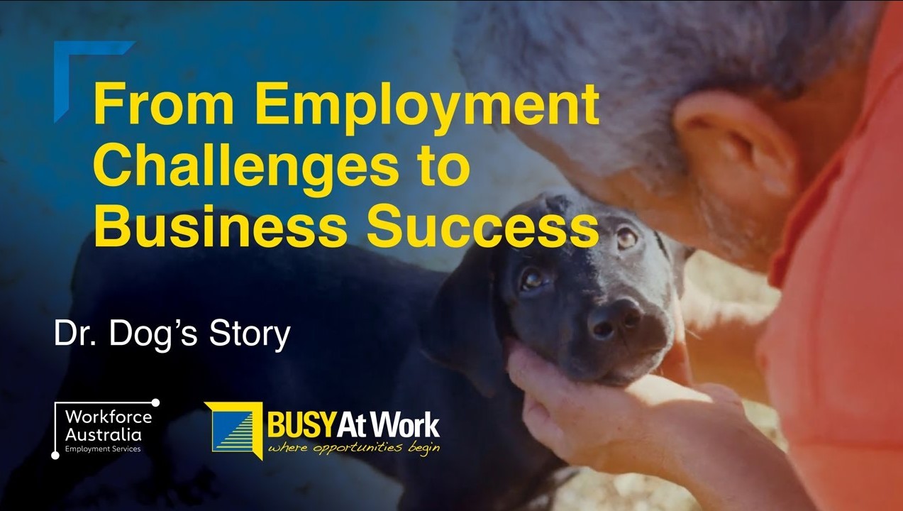 From Employment Challenges to Business Success - Dr. Dog’s Story." The thumbnail includes logos for "Workforce Australia Employment Services" and "BUSY At Work," suggesting that these organizations may be involved in the story or service being advertised. The focus of the image is a man lovingly looking at a black dog he is holding, indicating a possibly heartwarming or success story involving a canine element, potentially a therapy or service dog program