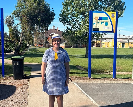 School girl standing in front of boarding school