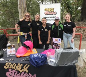 Group of women at a careers expo stall.