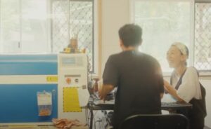 Man and woman laughing at work table