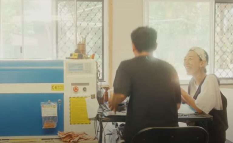 Man and woman laughing at work table