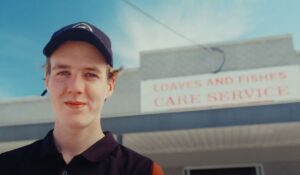 Young male outside of charity service Loaves and Fishes