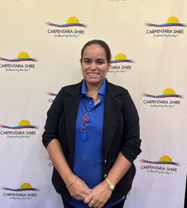 Young First Nations Female in front of Carpentaria Shire Council media wall